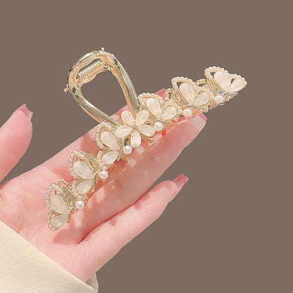 Large Gold Leaf Hair Claw Clip with Jade Flower in hand