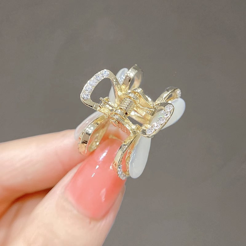 Mini bow hair claw clip for bangs and small sections styled from the side