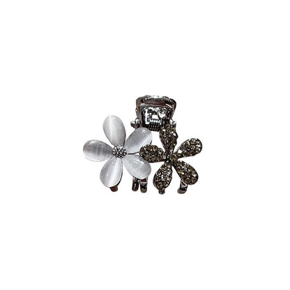 Small floral claw clip shown from an angled view for everyday styling