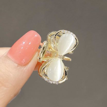 Close-up of the small bow claw clip with polished metallic detail