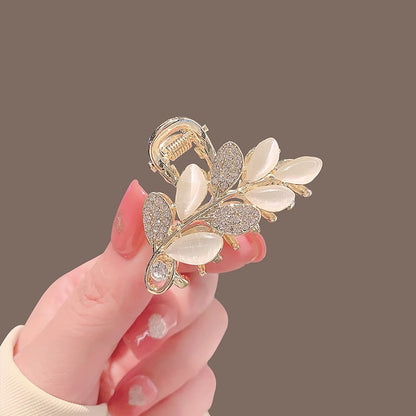 Mini leaf hair claw clip styled in a half-up hairstyle at the back of the head