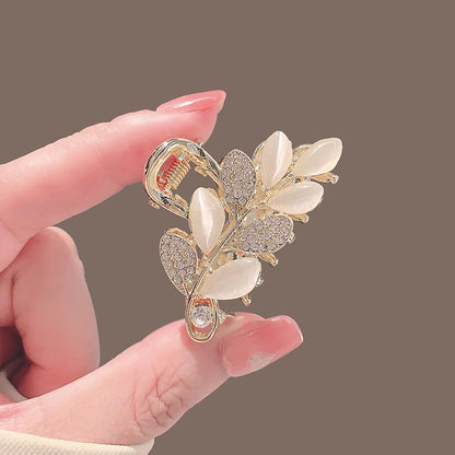 Close-up of the leaf-shaped mini claw clip with polished alloy finish