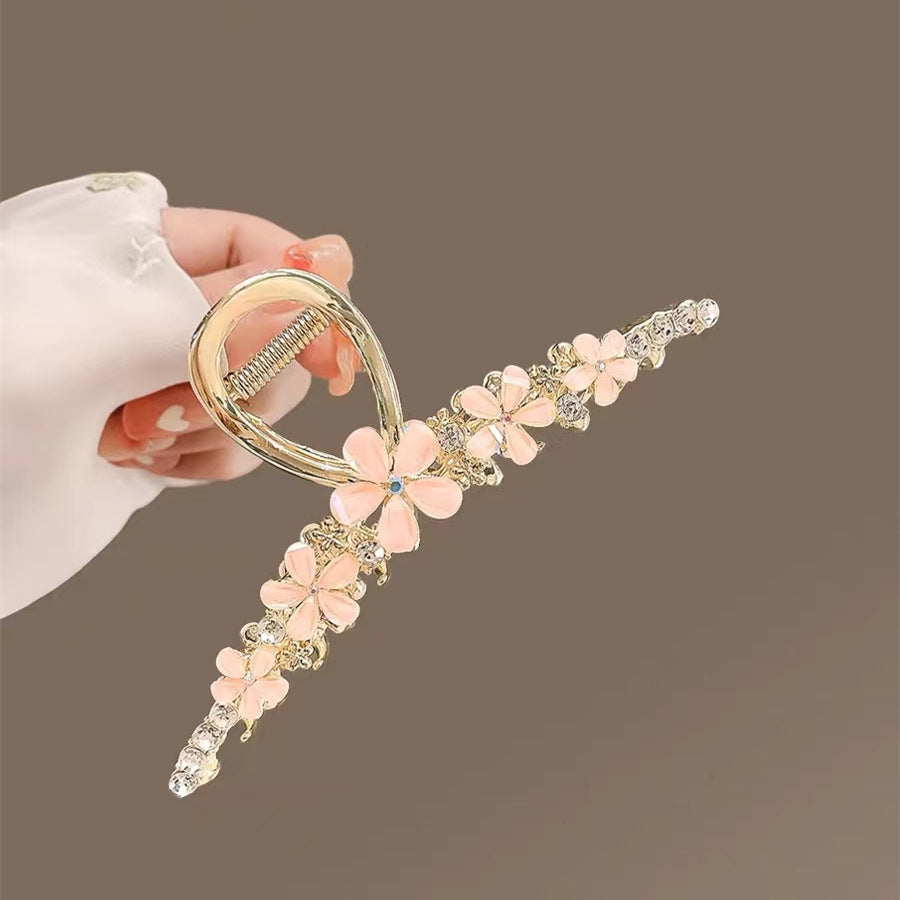Pink Camellia Large Hair Claw Clip with Rhinestones in hand