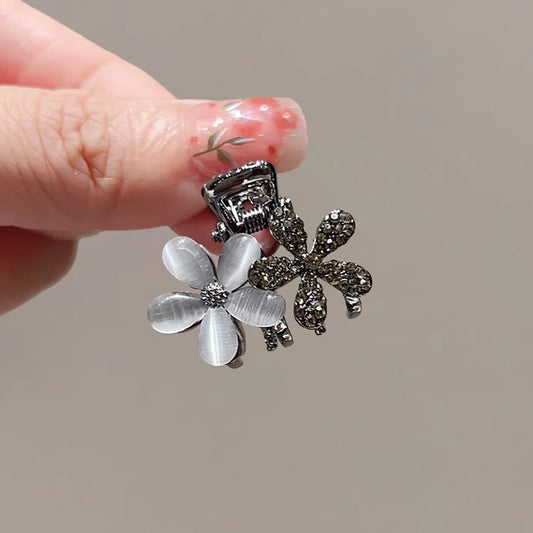 Cat-eye flower mini hair claw clip shown on a white background