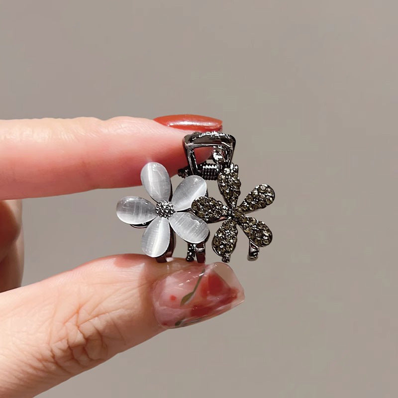 Close-up of the flower-shaped mini hair claw clip with polished detail