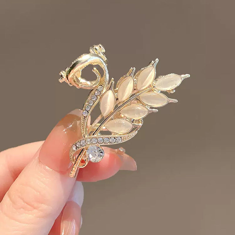 Gold Wheat Ear Hair Claw Clip for Half-Up Styling in hand