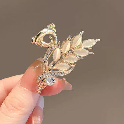 Gold Wheat Ear Hair Claw Clip for Half-Up Styling in hand