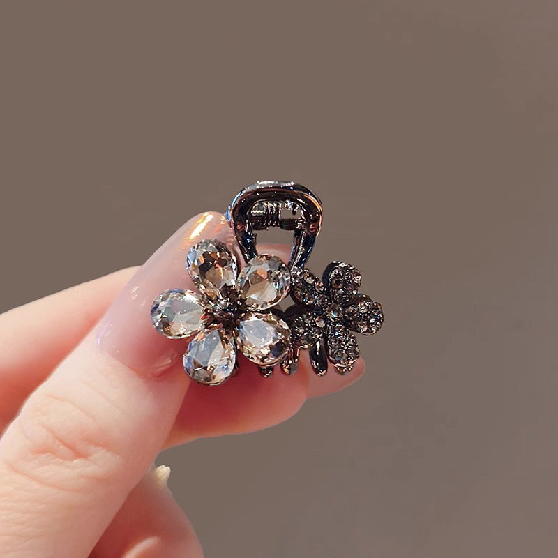 Model wearing the crystal flower small hair claw clip at the back of the head