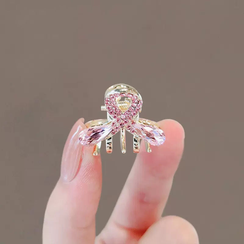 Small pink floral hair claw clip styled on wispy front hair