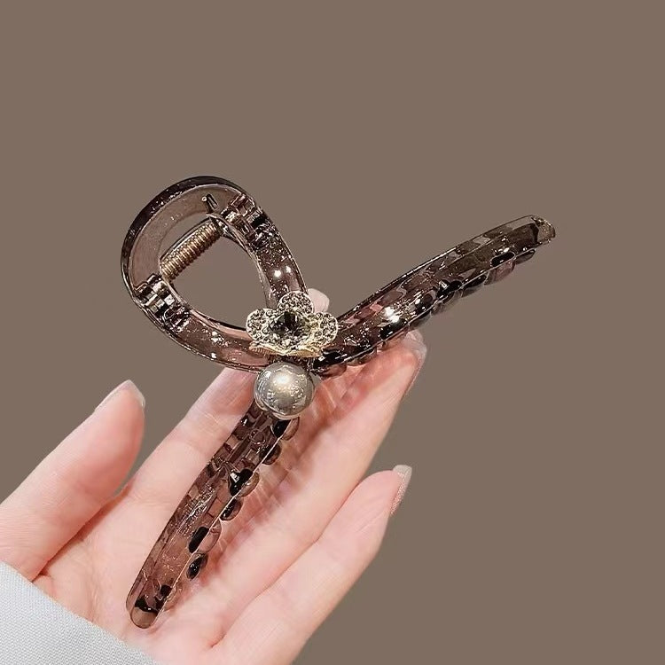 Brown Tortoiseshell Flat Hair Claw Clip with Pearl Flower in hand