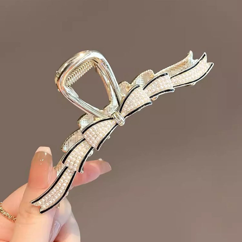 Gold Pearl Bow Hair Claw Clip in hand